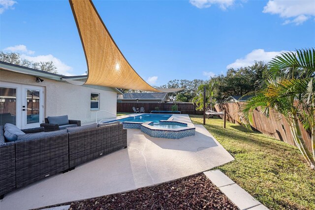 view of swimming pool featuring a lawn, french doors, an outdoor hangout area, an in ground hot tub, and a patio