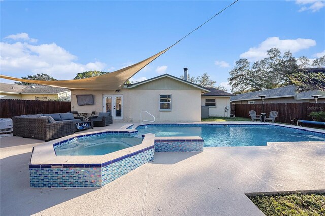 view of swimming pool featuring an outdoor living space, a patio area, an in ground hot tub, and french doors