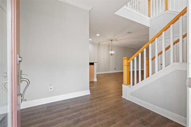 foyer entrance featuring a notable chandelier and dark wood-type flooring