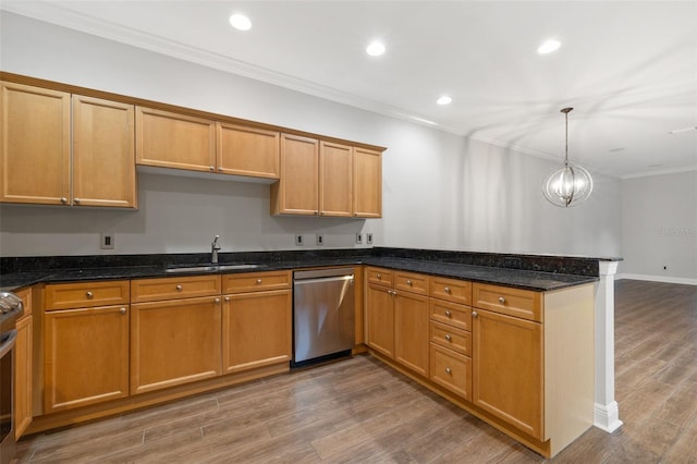 kitchen featuring sink, wood-type flooring, hanging light fixtures, dark stone counters, and appliances with stainless steel finishes