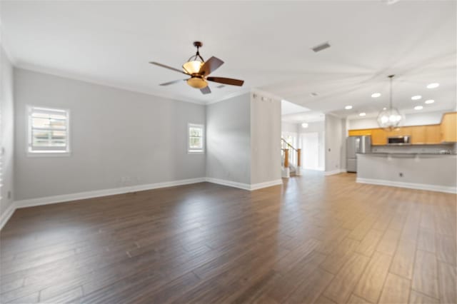 unfurnished living room with dark wood-type flooring, ceiling fan, and ornamental molding