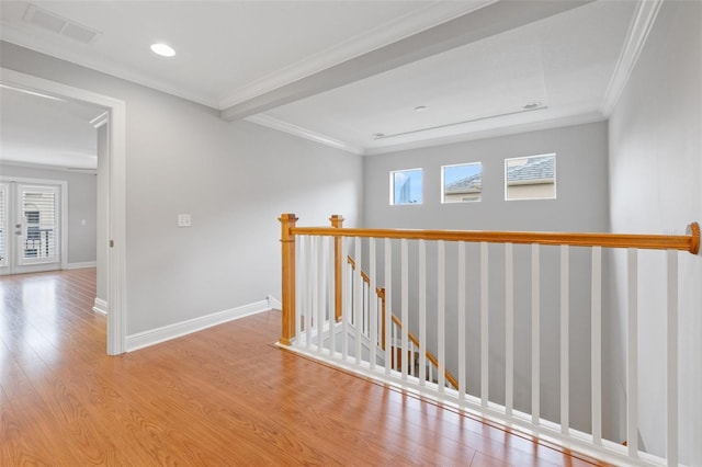 hall with ornamental molding and light wood-type flooring