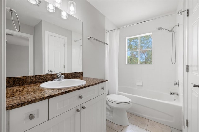 full bathroom featuring toilet, vanity, tile patterned floors, and shower / tub combo with curtain