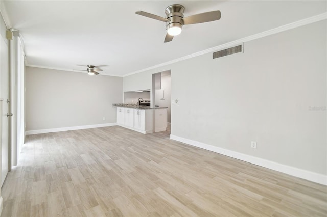 unfurnished living room featuring light wood-type flooring, ceiling fan, and crown molding