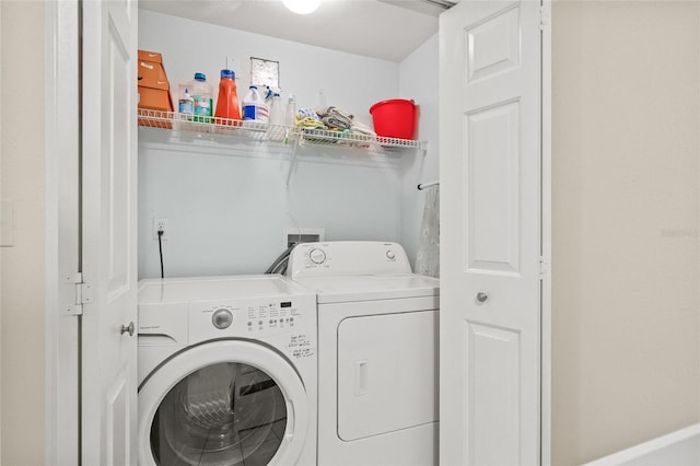 clothes washing area with washer and dryer