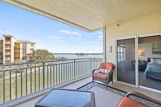 balcony featuring a water view