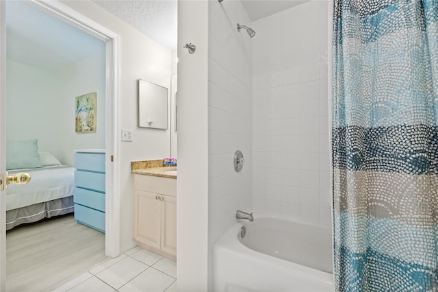 ensuite bathroom featuring ensuite bath, shower / bath combo, tile patterned flooring, and vanity