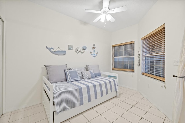 bedroom with ceiling fan and light tile patterned flooring