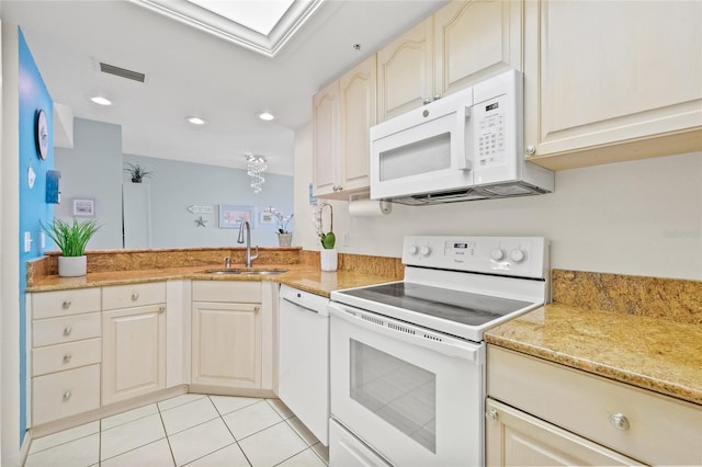 kitchen featuring light tile patterned floors, white appliances, a skylight, a sink, and visible vents