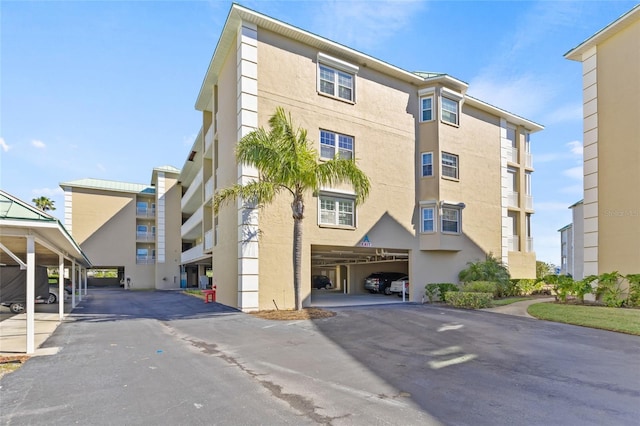 399 150th Ave Unit A203, Madeira Beach, FL 33708 - view of property with covered parking
