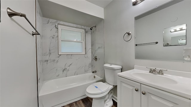 full bathroom with toilet, hardwood / wood-style floors, vanity, and tiled shower / bath combo