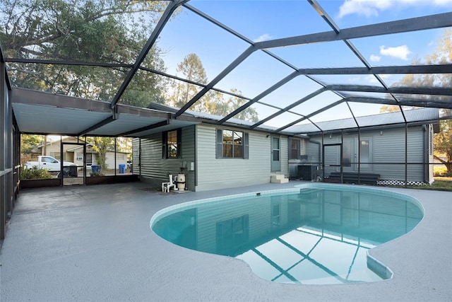 view of pool featuring a patio area and glass enclosure