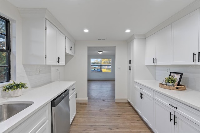 kitchen with white cabinetry, dishwasher, and light hardwood / wood-style floors