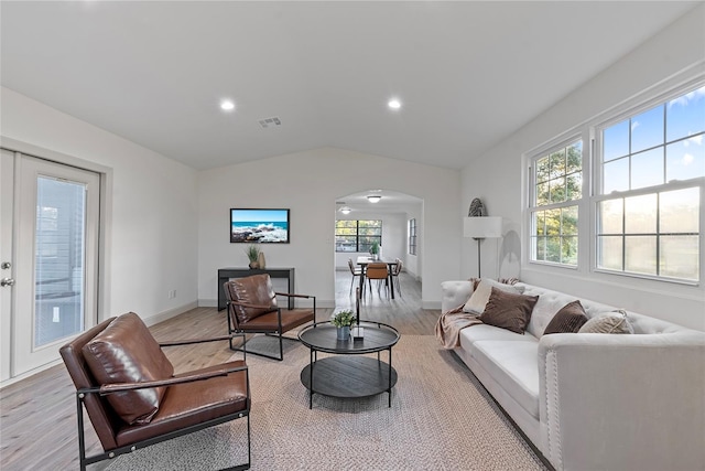 living room featuring light hardwood / wood-style flooring and vaulted ceiling