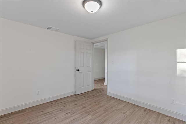 empty room with light hardwood / wood-style flooring