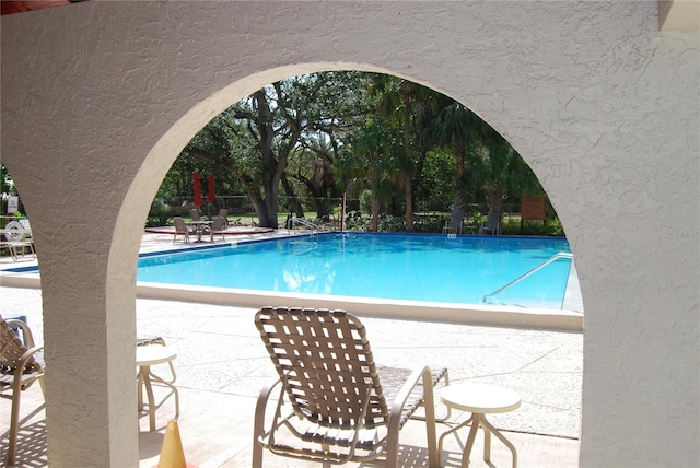 view of swimming pool with a patio area