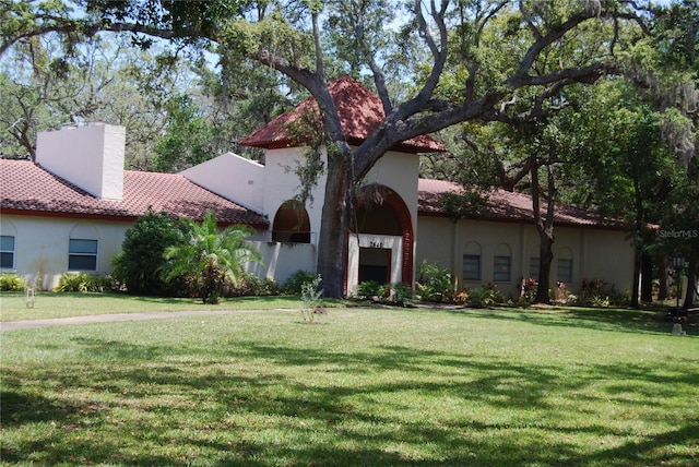 mediterranean / spanish house featuring a front lawn