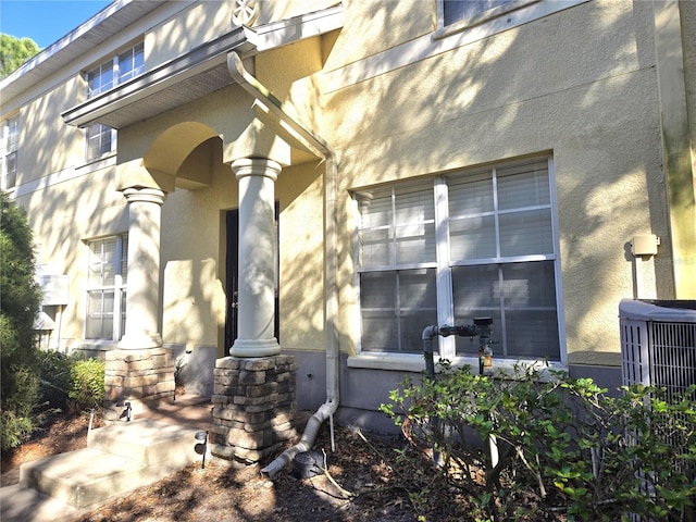 entrance to property featuring cooling unit