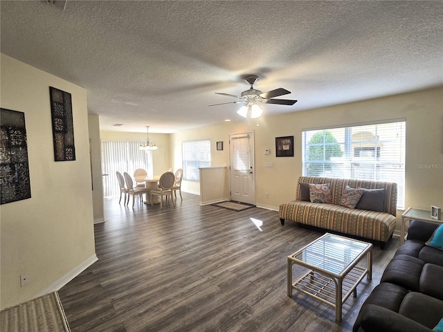 living room featuring a textured ceiling, ceiling fan, and dark hardwood / wood-style floors