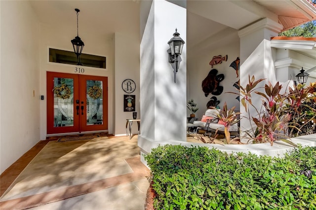 doorway to property featuring covered porch and french doors