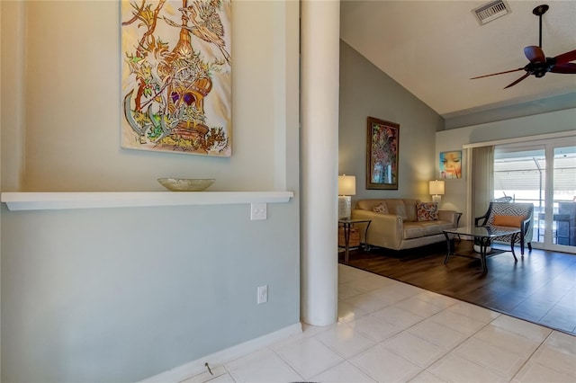 living room featuring ceiling fan, light hardwood / wood-style flooring, and lofted ceiling