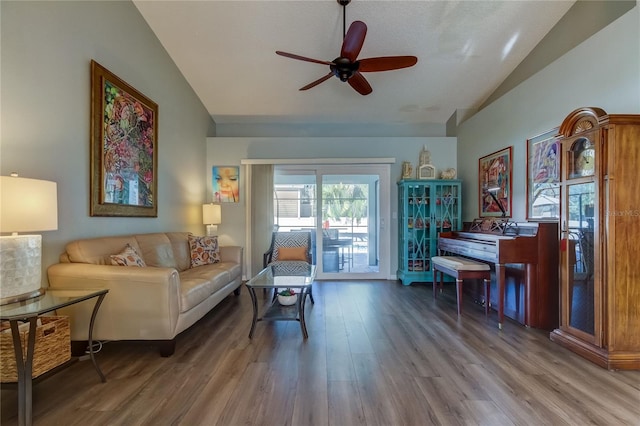 living room featuring hardwood / wood-style floors, ceiling fan, and lofted ceiling