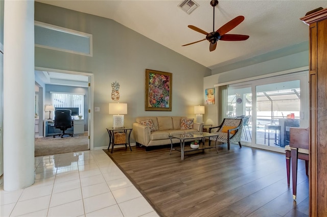 living room with light hardwood / wood-style flooring, plenty of natural light, lofted ceiling, and ceiling fan