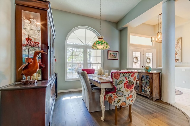 dining area with light hardwood / wood-style flooring and a chandelier