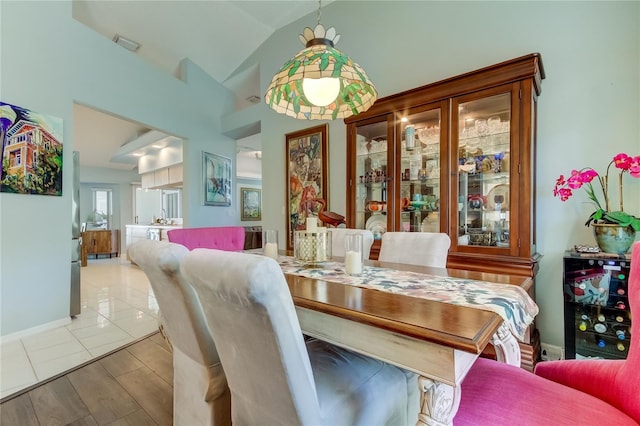 dining area featuring light hardwood / wood-style flooring and lofted ceiling