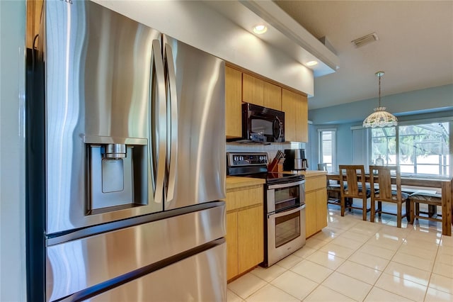 kitchen with light tile patterned floors, stainless steel appliances, decorative light fixtures, and a notable chandelier