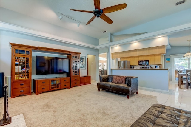 living room featuring track lighting, light colored carpet, vaulted ceiling, and ceiling fan