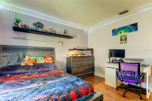 bedroom featuring hardwood / wood-style floors and a textured ceiling