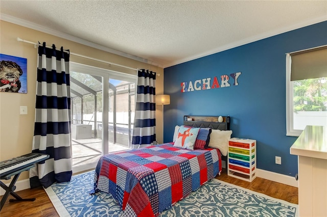 bedroom featuring wood-type flooring, a textured ceiling, access to outside, and crown molding