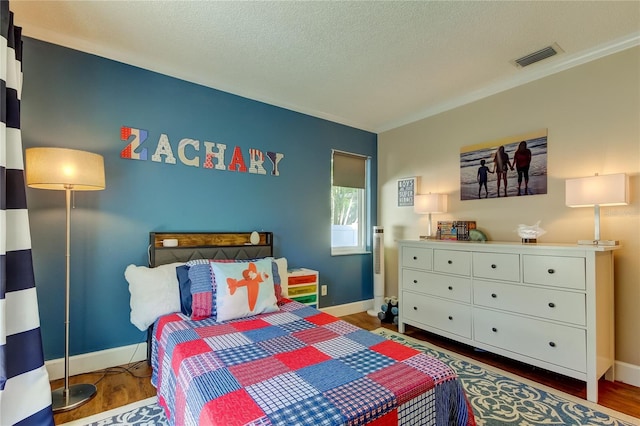 bedroom with dark wood-type flooring and a textured ceiling