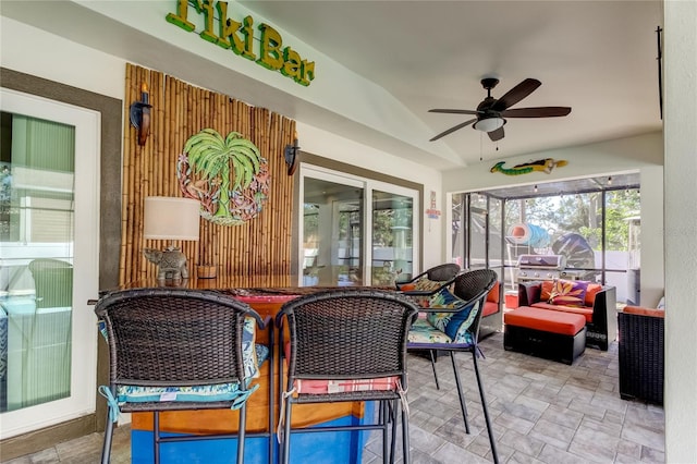 sunroom / solarium with ceiling fan and lofted ceiling