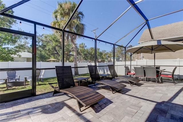 view of patio featuring a lanai