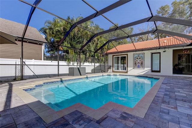 view of pool featuring glass enclosure and a patio area