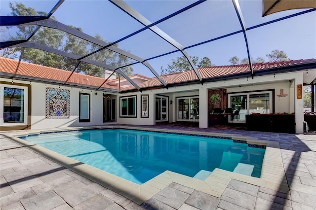 view of pool featuring an outdoor living space, ceiling fan, a patio, and glass enclosure