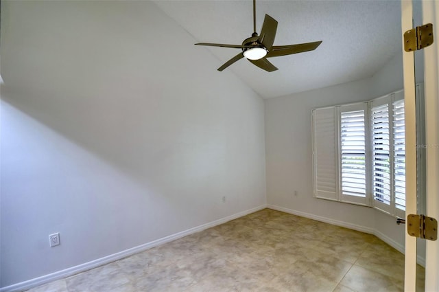 empty room featuring ceiling fan and lofted ceiling