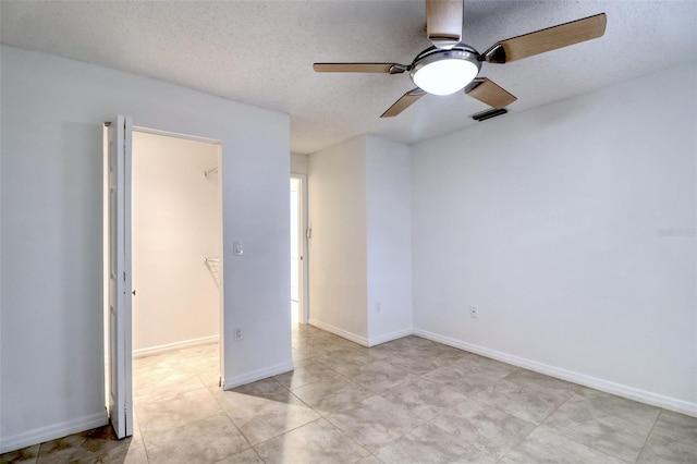 spare room featuring a textured ceiling and ceiling fan