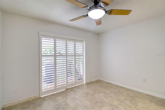 spare room with ceiling fan and a textured ceiling