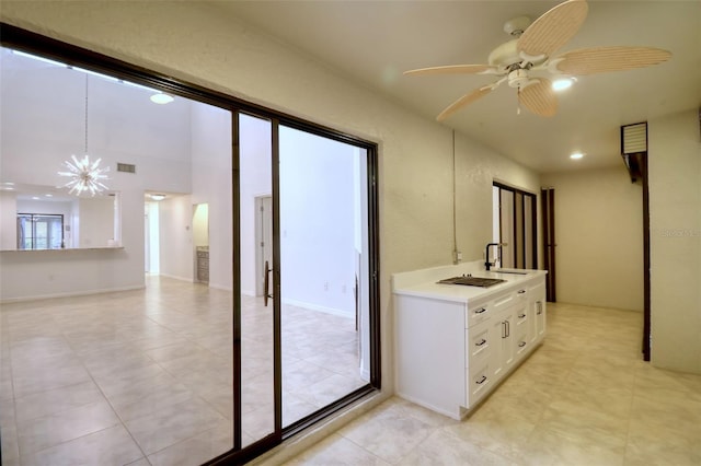 bathroom with ceiling fan with notable chandelier