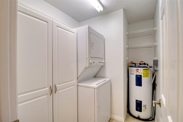 clothes washing area with a textured ceiling, water heater, and stacked washer and clothes dryer