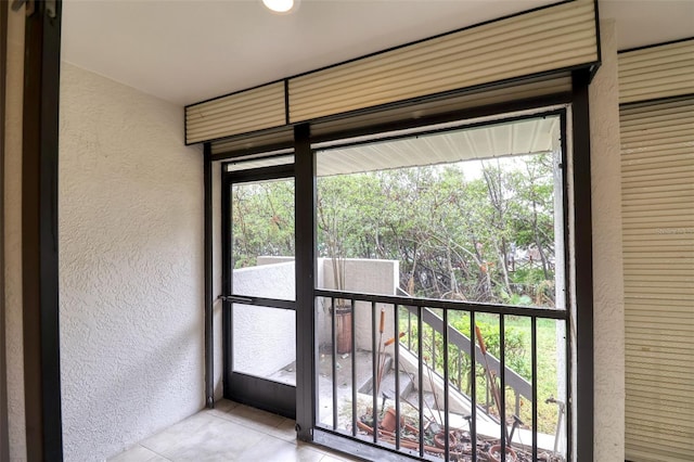 doorway featuring light tile patterned flooring