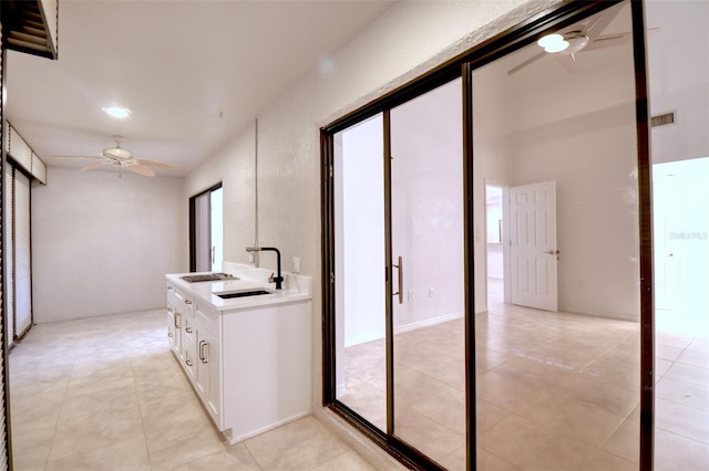 hallway with sink and light tile patterned floors