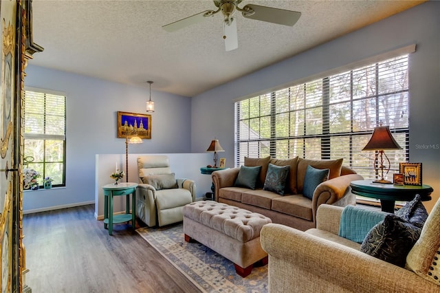 living room featuring hardwood / wood-style floors, a textured ceiling, a wealth of natural light, and ceiling fan