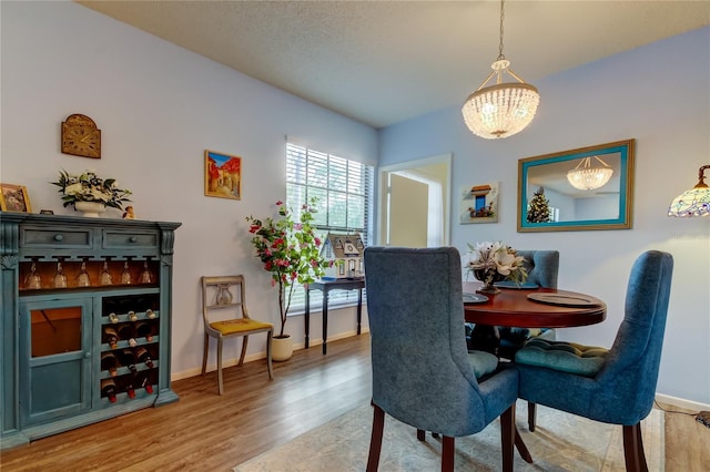 dining space featuring a chandelier and wood-type flooring