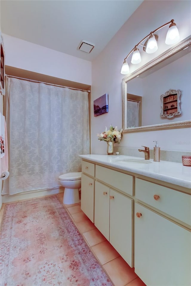 bathroom with tile patterned floors, vanity, and toilet