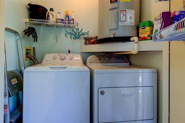 washroom with water heater and washing machine and clothes dryer