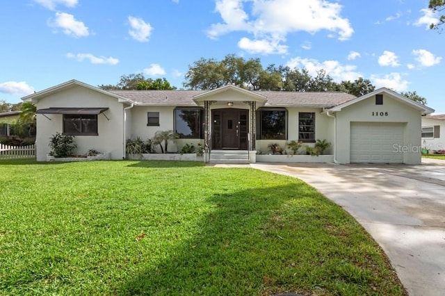 ranch-style home featuring a front yard and a garage